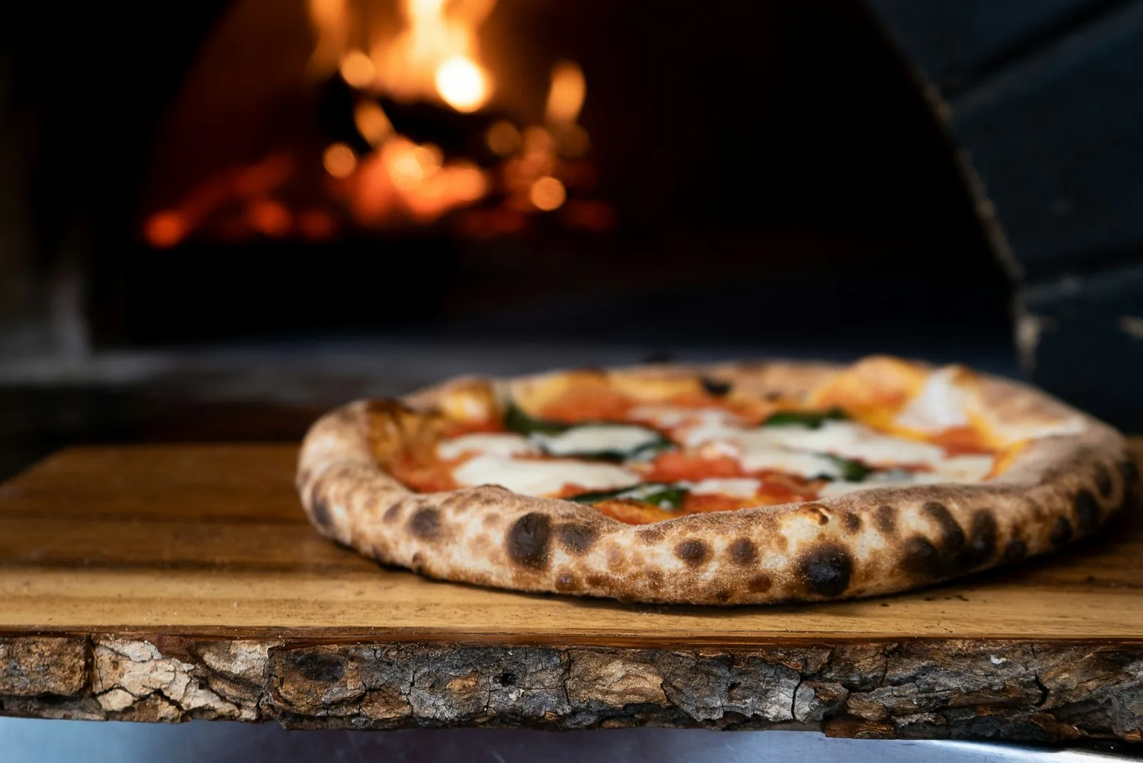 Pizza margherita davanti a un forno acceso